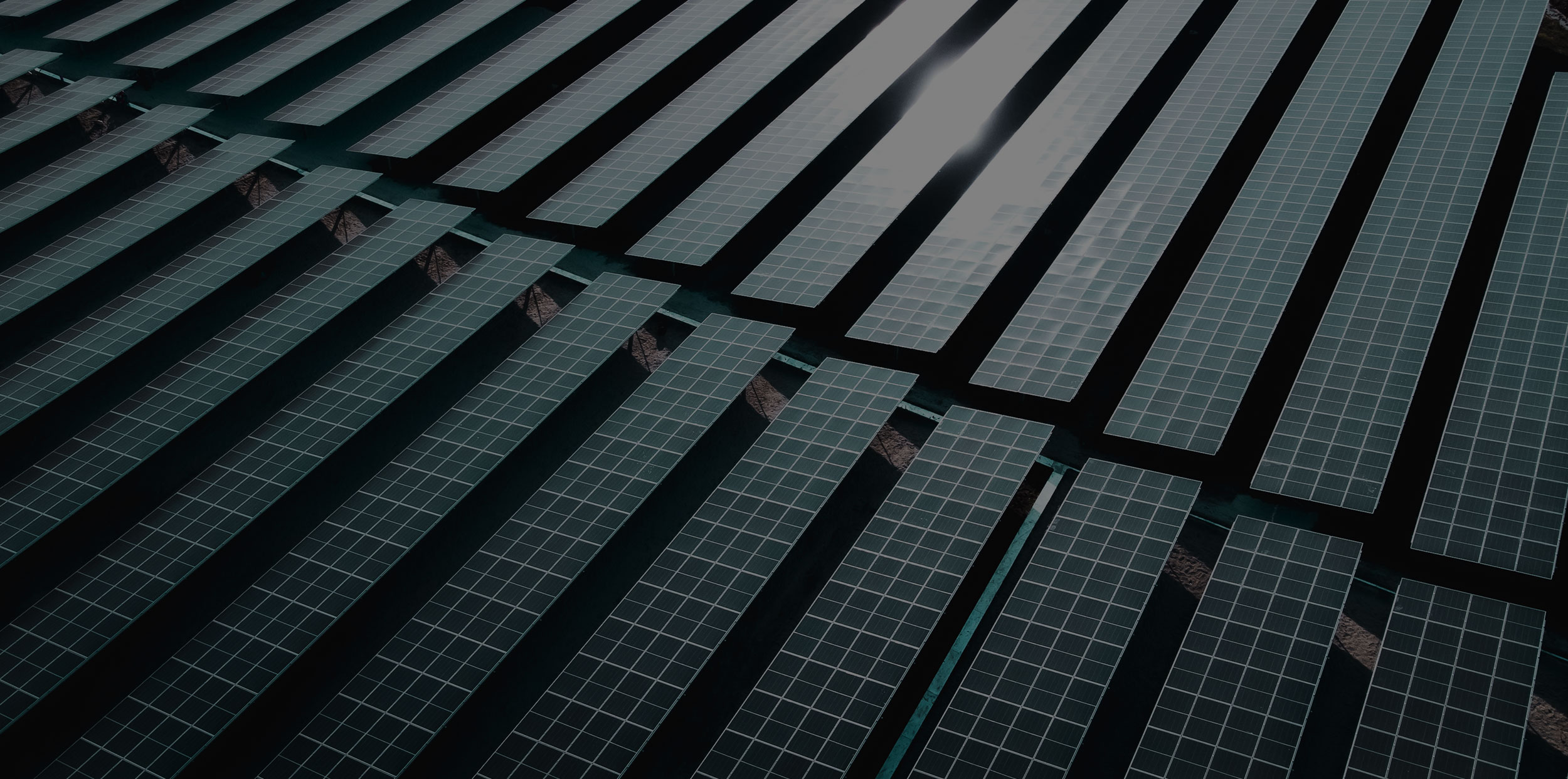 Large-scale solar panel array at an industrial energy facility